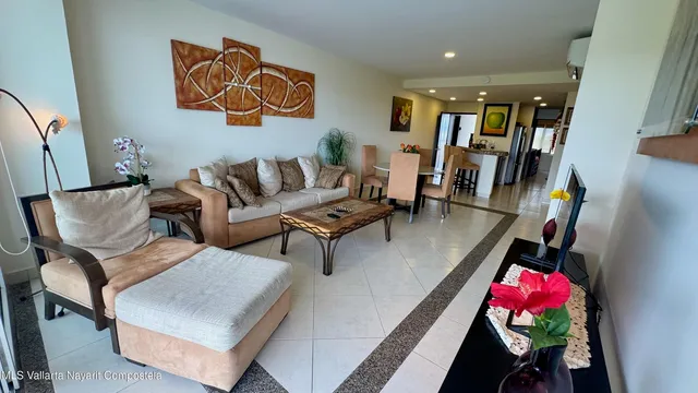 a living room with furniture and flowers