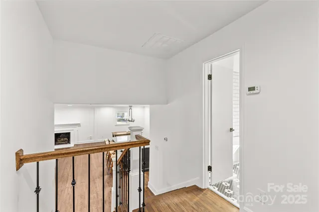 a view of hallway with wooden floor