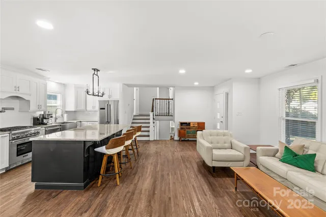 a living room with furniture and kitchen view