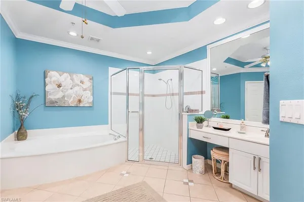 a bathroom with a bathtub a shower a sink and a mirror