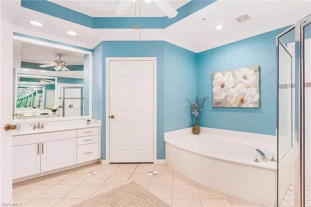 a bathroom with a sink a large mirror and a bathtub