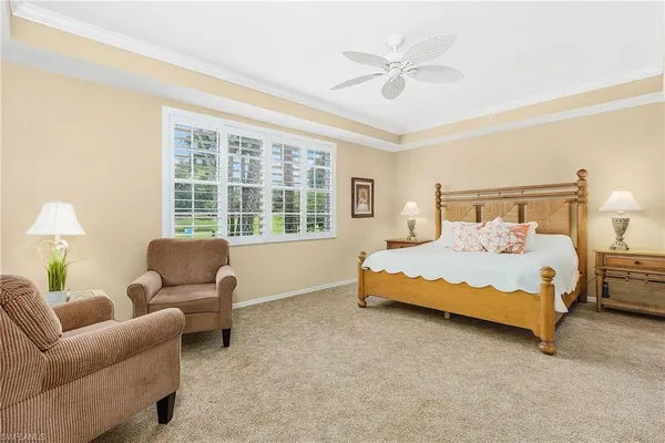 a bedroom with a bed couches and a large window with outer view