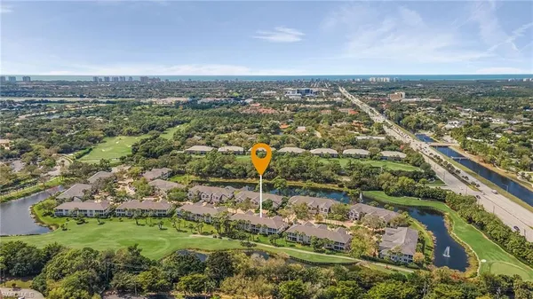 an aerial view of residential building and lake