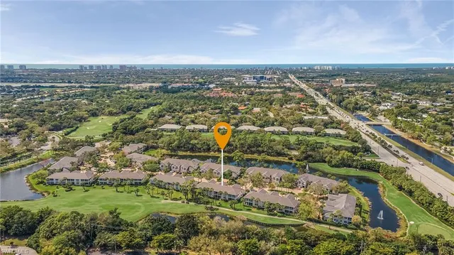 an aerial view of residential building and lake