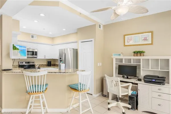 a kitchen with stainless steel appliances a stove a refrigerator and a stove top oven