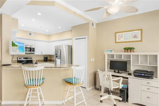 a kitchen with stainless steel appliances a stove a refrigerator and a stove top oven