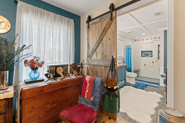 a living room with furniture stairs and a window