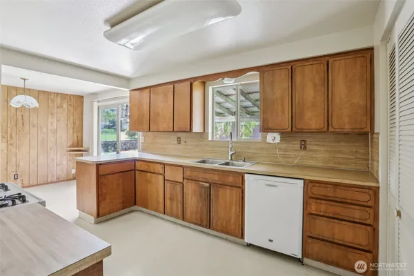 a kitchen with sink window and cabinets