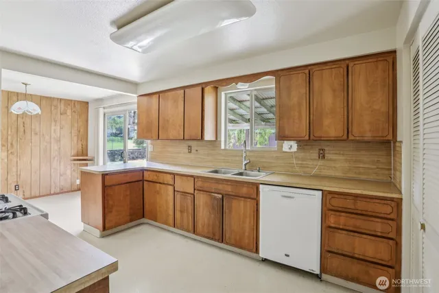 a kitchen with sink window and cabinets