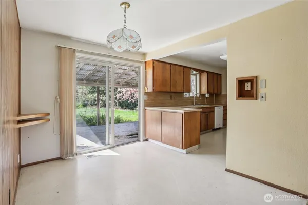 a open kitchen with cabinets a stove and a refrigerator