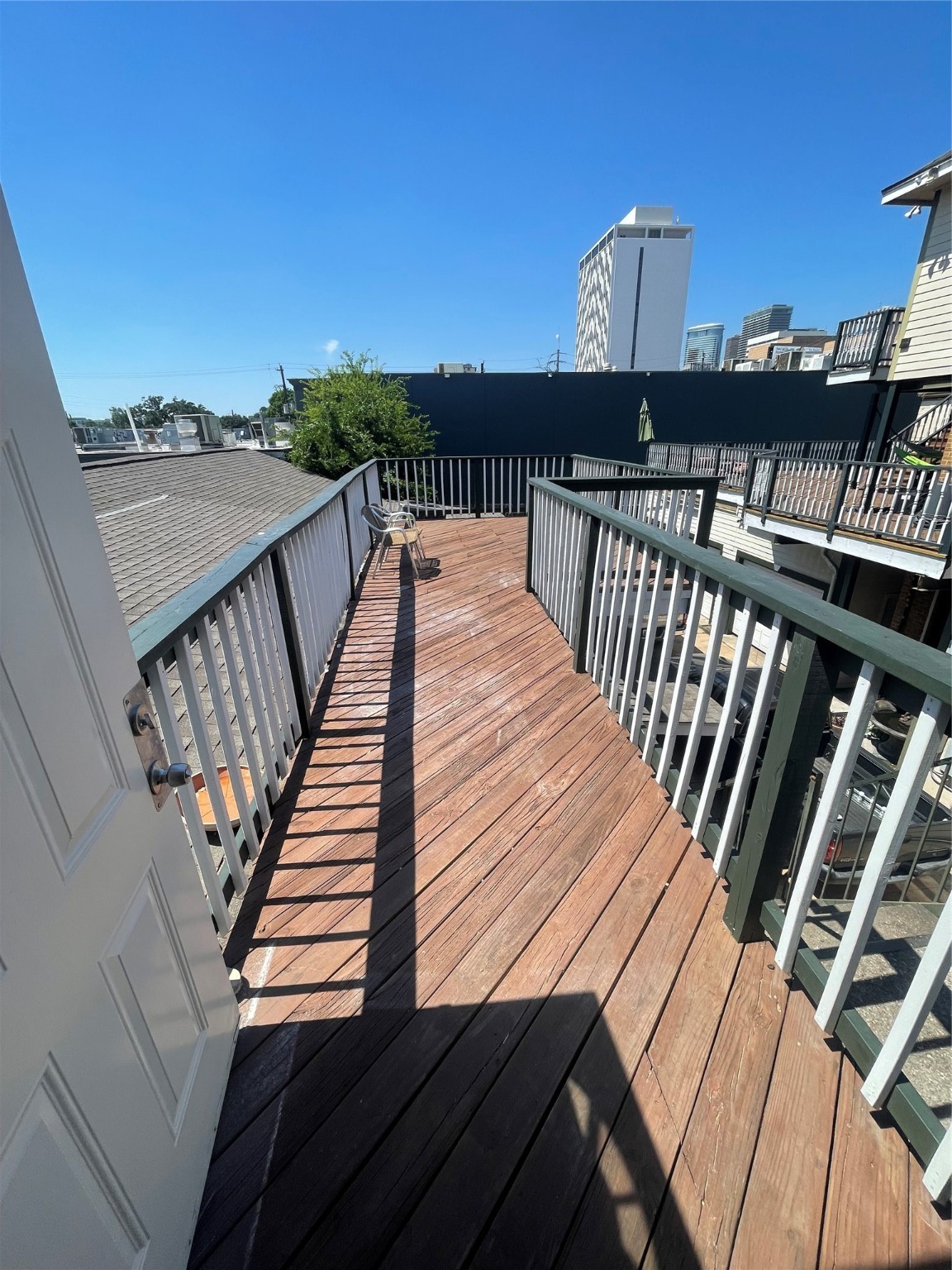2110 Chenevert Street, Unit 8 Houston, TX 77003 - Photo 11 of 12 a view of balcony with wooden floor and fence