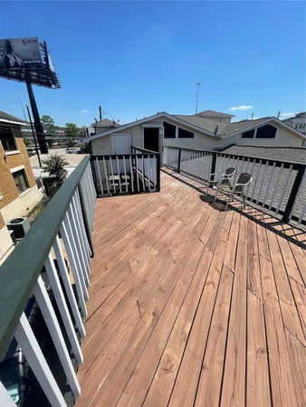 a view of a balcony with two chairs and a barbeque