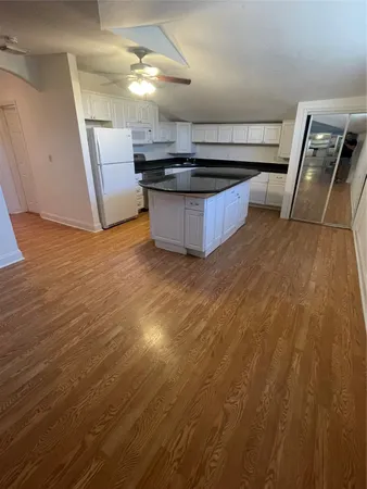 a kitchen with granite countertop a sink and a stove top oven