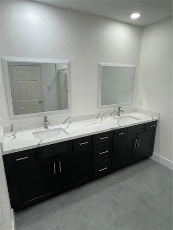 a bathroom with a double vanity sink and mirror