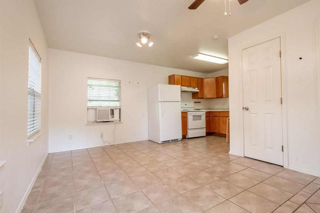 4704 Evans Avenue, Unit B Austin, TX 78751 - Photo 7 of 8 Kitchen with brown cabinetry, white appliances, light countertops, ceiling fan, and cooling unit