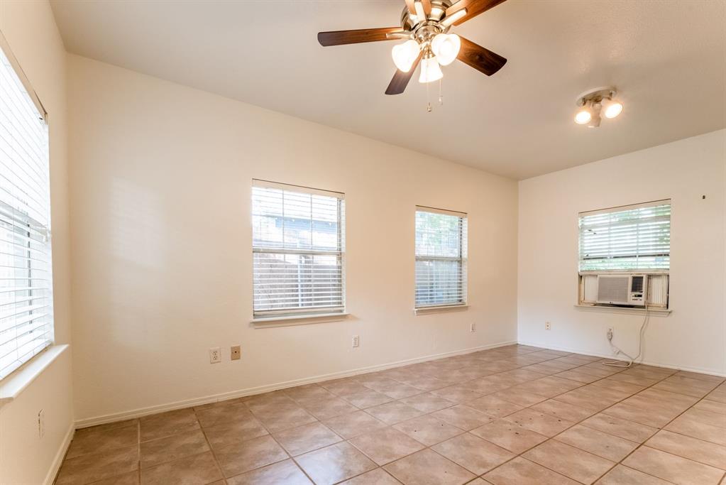 4704 Evans Avenue, Unit B Austin, TX 78751 - Photo 8 of 8 Room featuring a ceiling fan, cooling unit, and light tile patterned flooring.