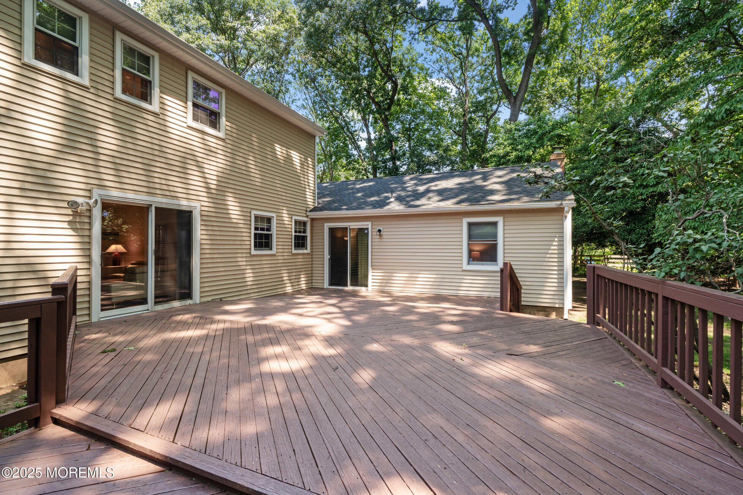 4 Hamilton Hill Road Lincroft, NJ 07738 - Photo 40 of 44 a view of a house with a yard and lawn chairs with wooden floor