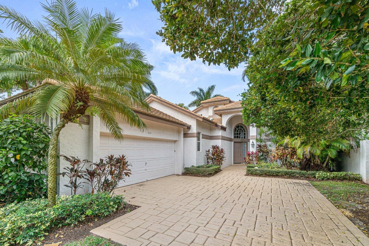 5537 Northwest 21st Way Boca Raton, FL 33496 - Photo 1 of 27 a front view of a house with garden