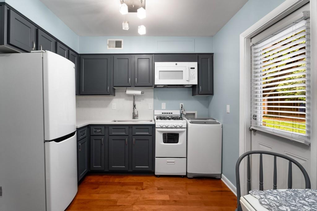 148 Waverly Way Northeast, Unit 6 Atlanta, GA 30307 - Photo 11 of 32 a kitchen with a refrigerator and a sink