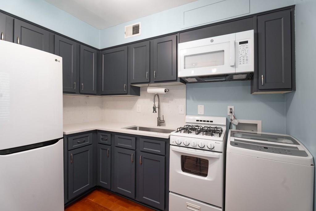 148 Waverly Way Northeast, Unit 6 Atlanta, GA 30307 - Photo 3 of 32 a kitchen with a cabinets and white appliances