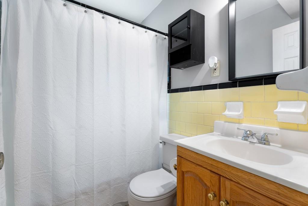 148 Waverly Way Northeast, Unit 6 Atlanta, GA 30307 - Photo 8 of 32 a bathroom with a sink vanity mirror and toilet