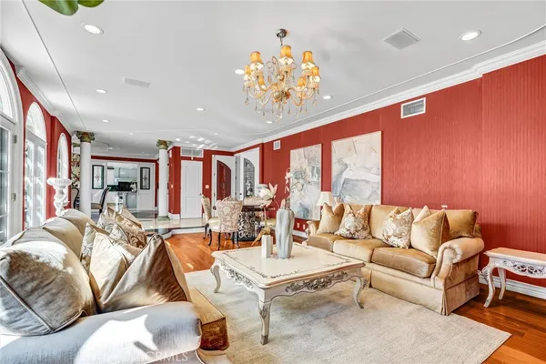 a view of a dining room with furniture and chandelier