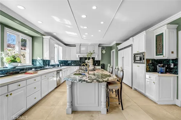 a kitchen with center island table and chairs