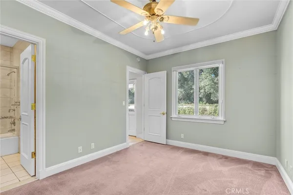 a living room with furniture chandelier and a large window