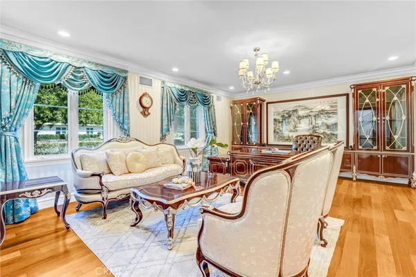 a living room with furniture and a chandelier