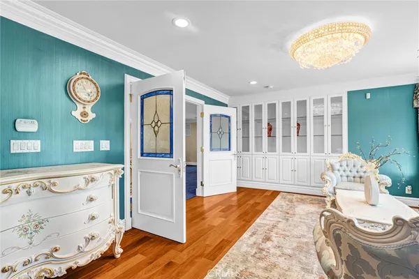 a bedroom with a bed and a chandelier