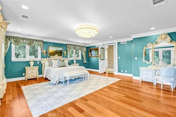 a bed room with a bed and a chandelier