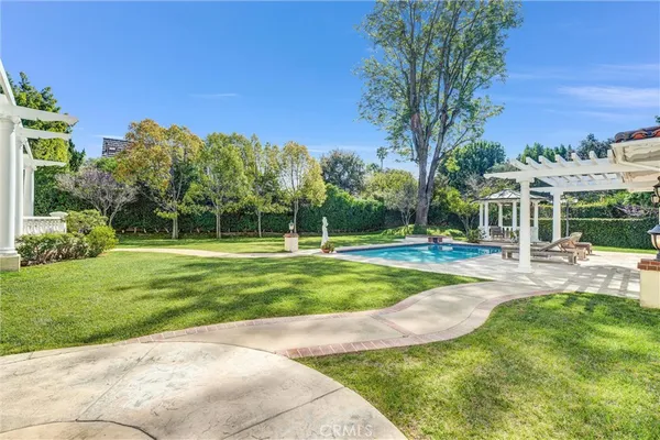 a view of a house with swimming pool and a yard