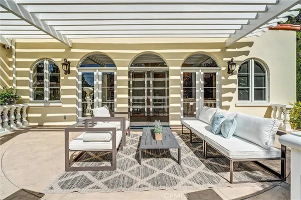a view of an house with swimming pool lawn chairs and a yard