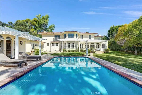 a living room with fireplace furniture and a chandelier