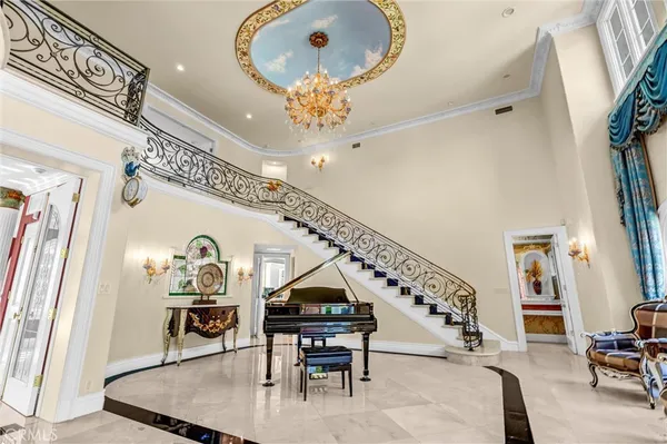 a living room with furniture a table and large windows
