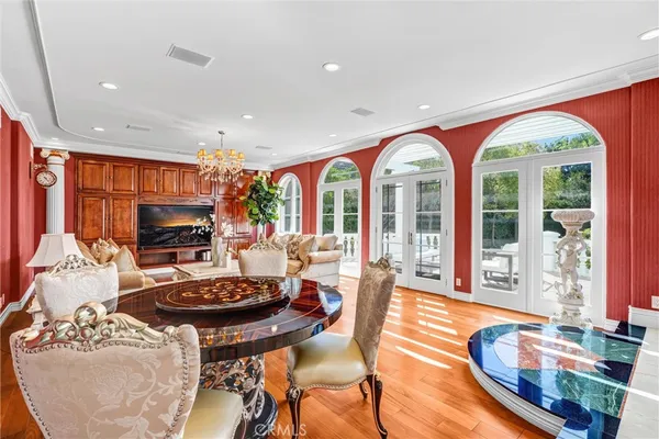 a living room with fireplace furniture and a large window