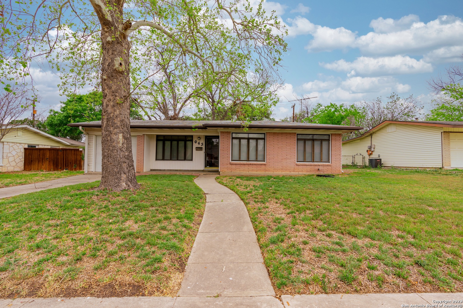 a front view of house with yard and green space
