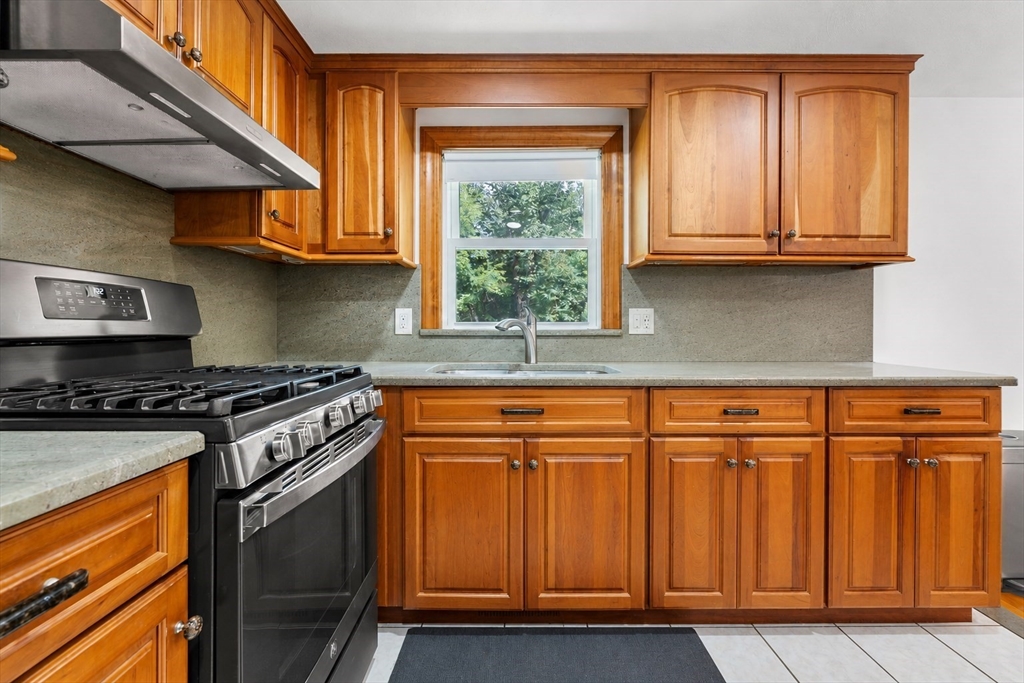 8 Governor Fuller Road Billerica, MA 01821 - Photo 15 of 33 a kitchen with stainless steel appliances granite countertop wooden cabinets a sink and a stove