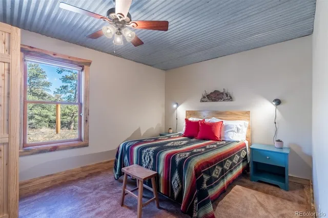 a bedroom with a bed a chandelier and closet