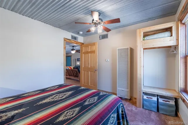 a room with a bed and a chandelier