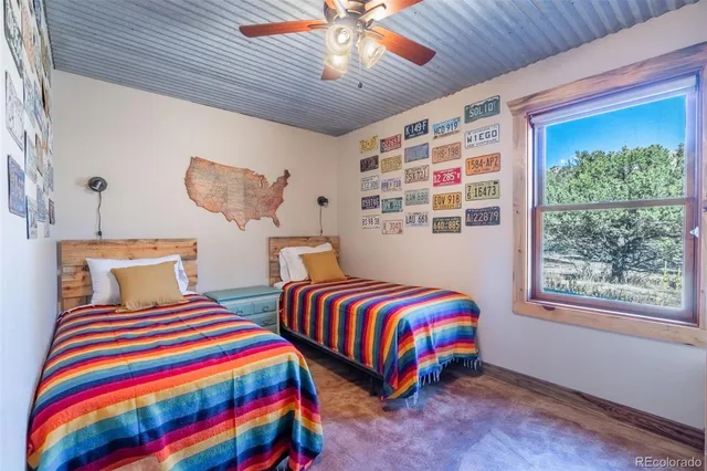 a bedroom with two beds and a chandelier