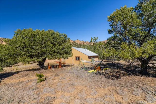 a view of a house with a tree in the background