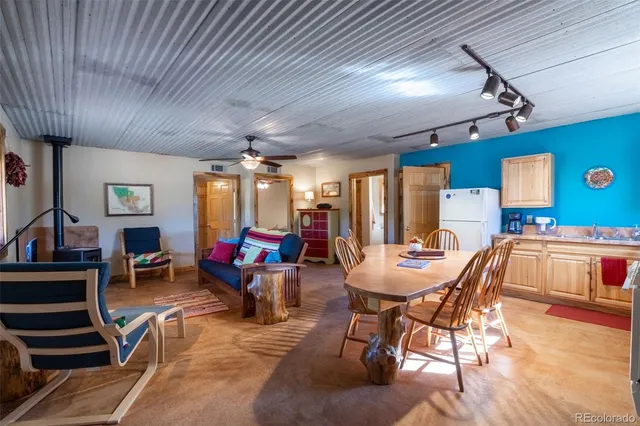 a living room with furniture a wooden floor and ceiling fan