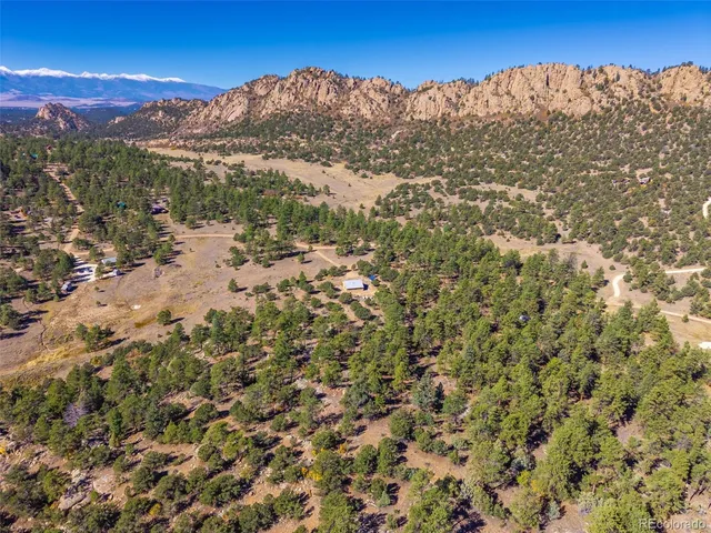 a view of a field with mountains in the background