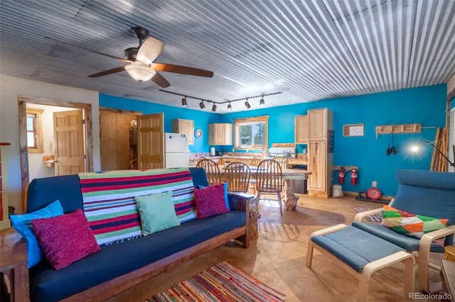 a living room filled with furniture and a pool table