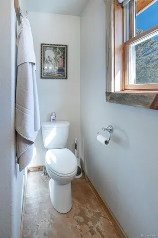 a white toilet sitting next to a window