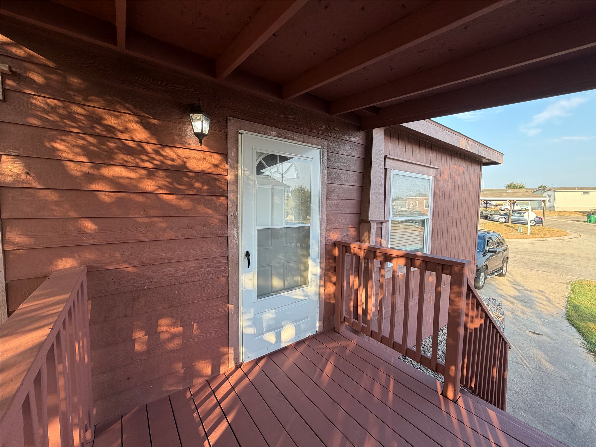 13021 Dessau Road, Unit 393 Austin, TX 78754 - Photo 1 of 10 An inviting covered entry porch features wood plank flooring and coordinating rustic timber railings.