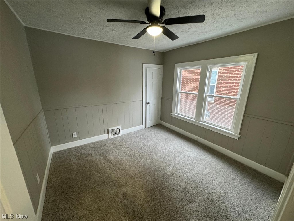 3333 Berea Road Cleveland, OH 44111 - Photo 20 of 34 Unfurnished room featuring light carpet, a textured ceiling, and ceiling fan
