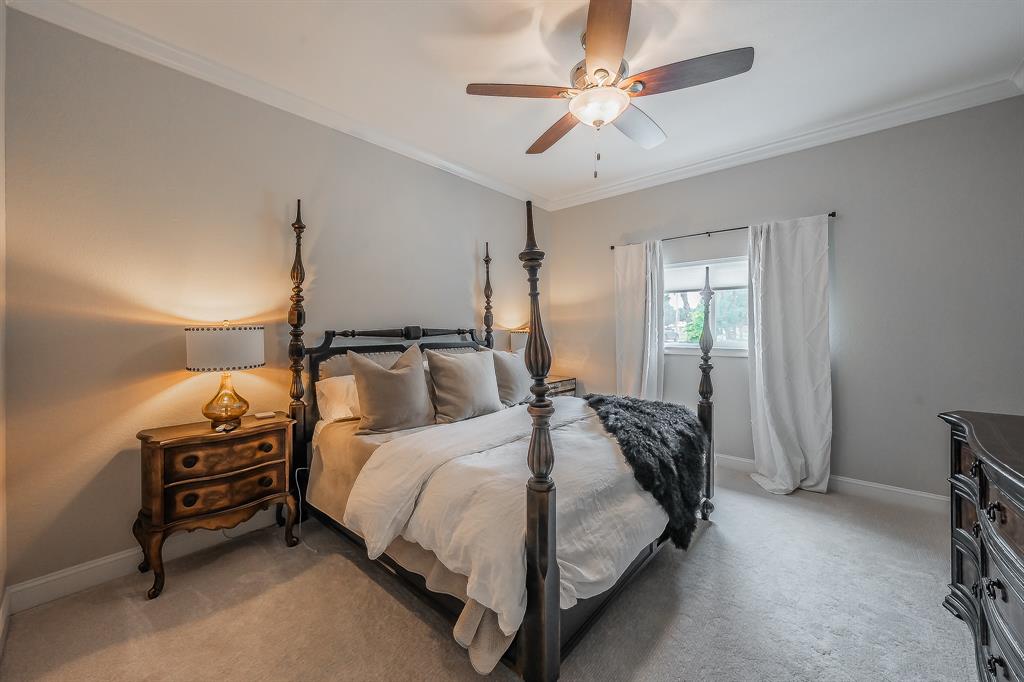 115 Pheasant Run Road Argyle, TX 76226 - Photo 31 of 40 a bedroom with a bed and a chandelier