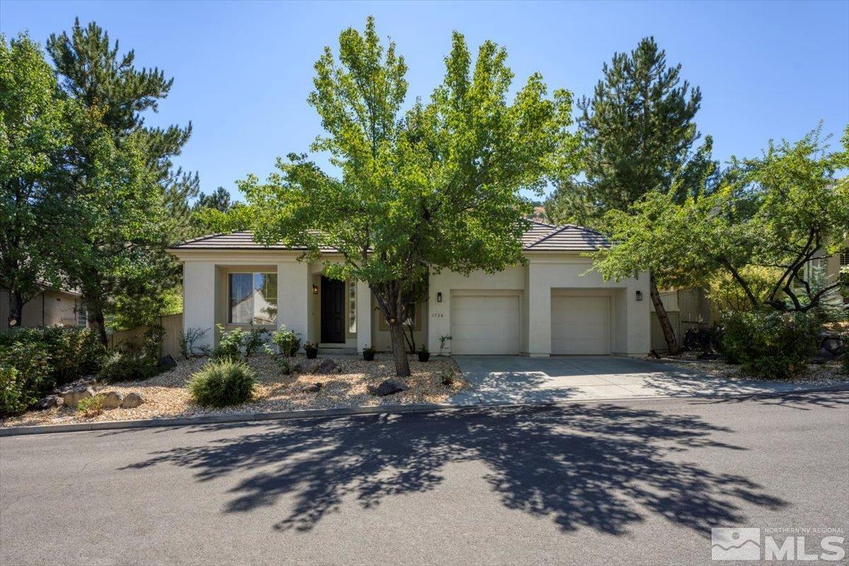1730 Hunter Creek Road Reno, NV 89519 - Photo 1 of 39 a front view of a house with a garden